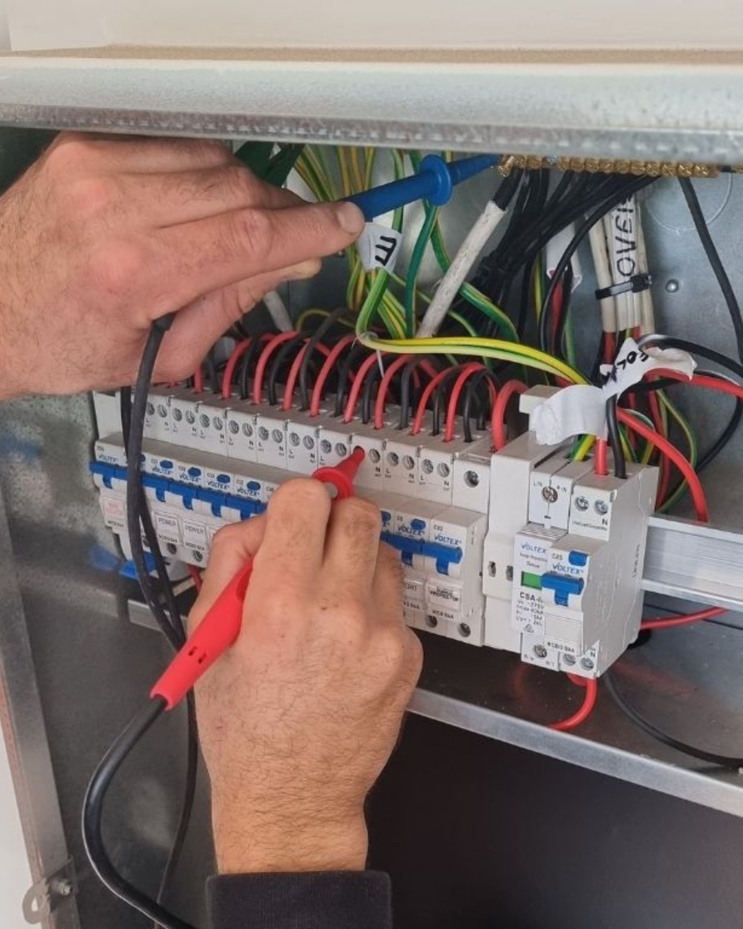 A photo showing Quality Electrical Contracting working on a switchboard upgrade